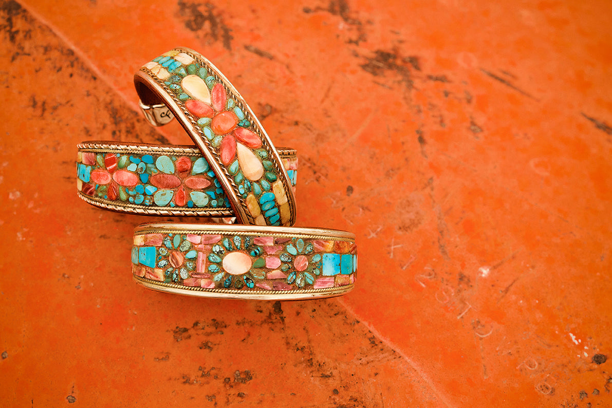 Assorted Charlie Favour cuffs styled in a laydown image.