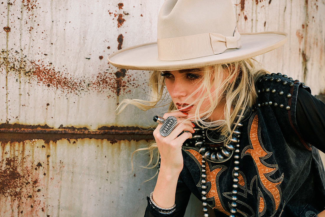 Haley wearing the Pipeline Tee with stacks of desert pearl necklaces and Double D Ranch accessories.