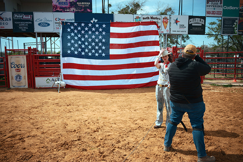 Mitchell shooting Kaylin in front of a huge American Flag.