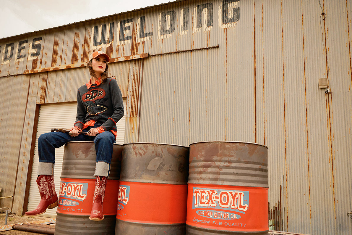 Kaylin wearing the Fueled by Fashion Tee with the Jake shirt, and Spaghetti Western Boots.